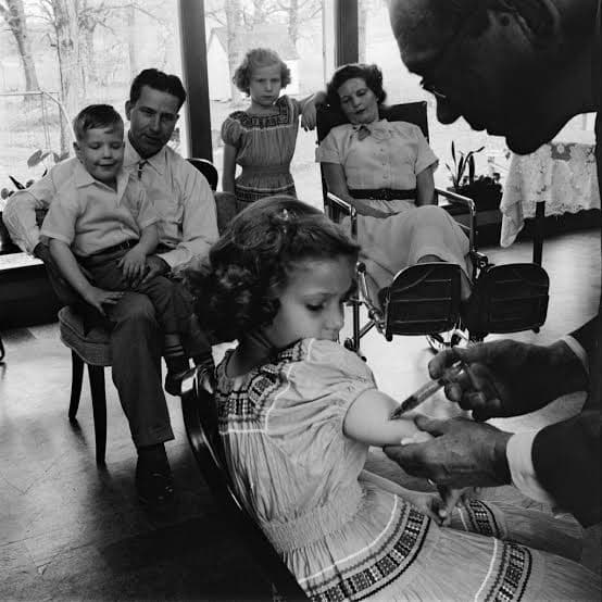 Schoolchildren line up for the polio shot.