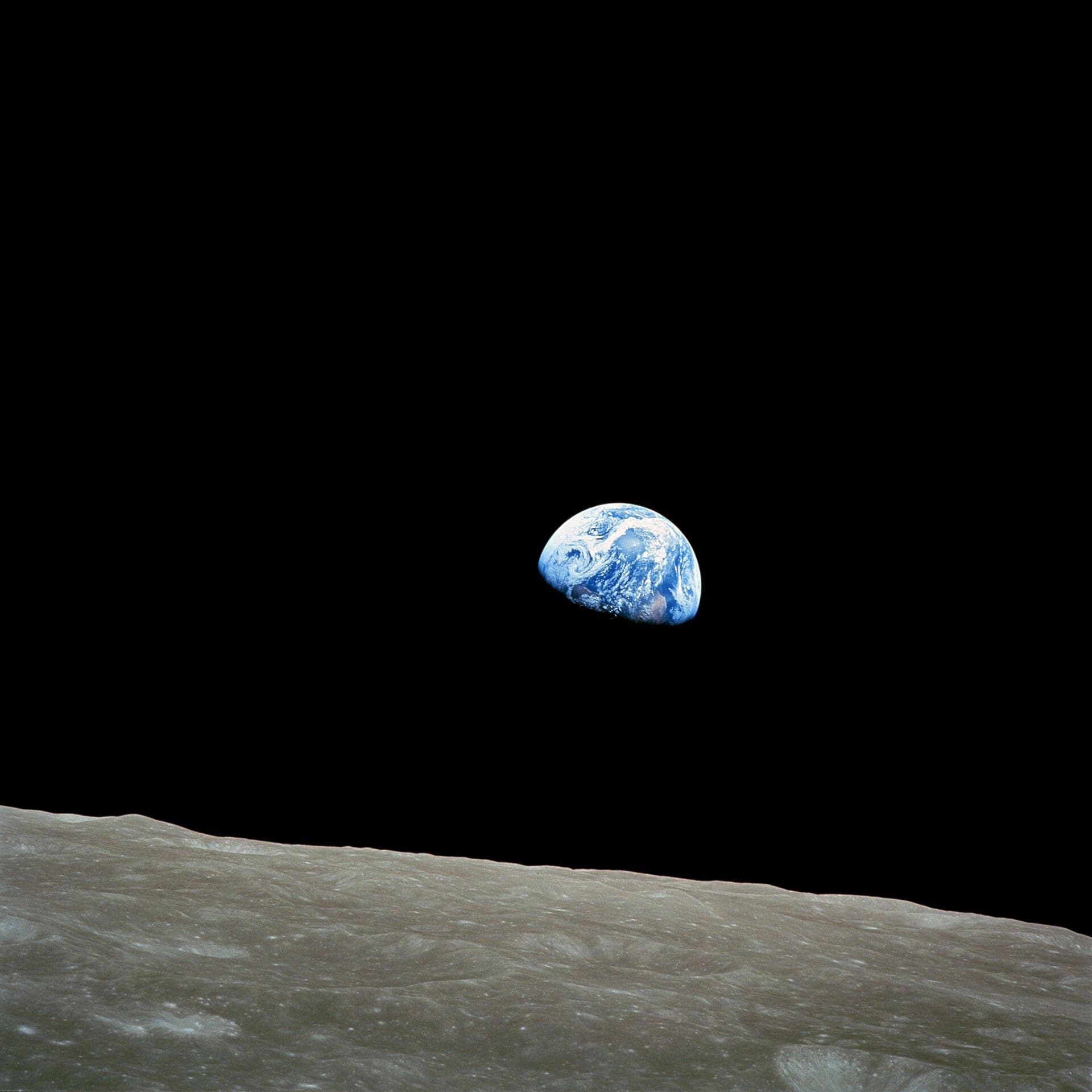 The Earth rising over the lunar horizon, photographed from Apollo 8