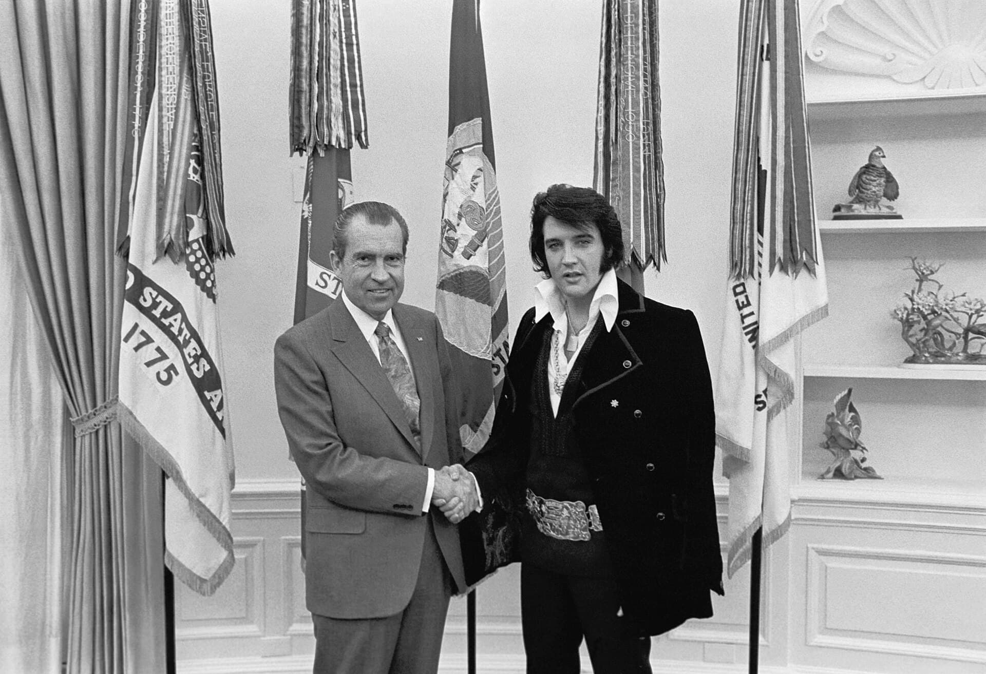 Elvis Presley shaking hands with President Richard Nixon in the Oval Office