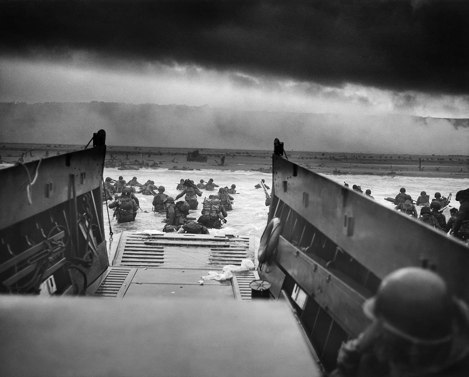 U.S. soldiers wading ashore from a landing craft toward Omaha Beach on D-Day