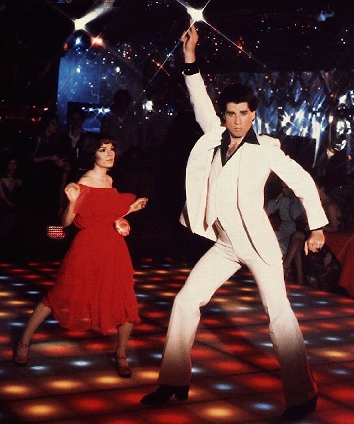 The white-suit, finger-to-the-sky disco pose.