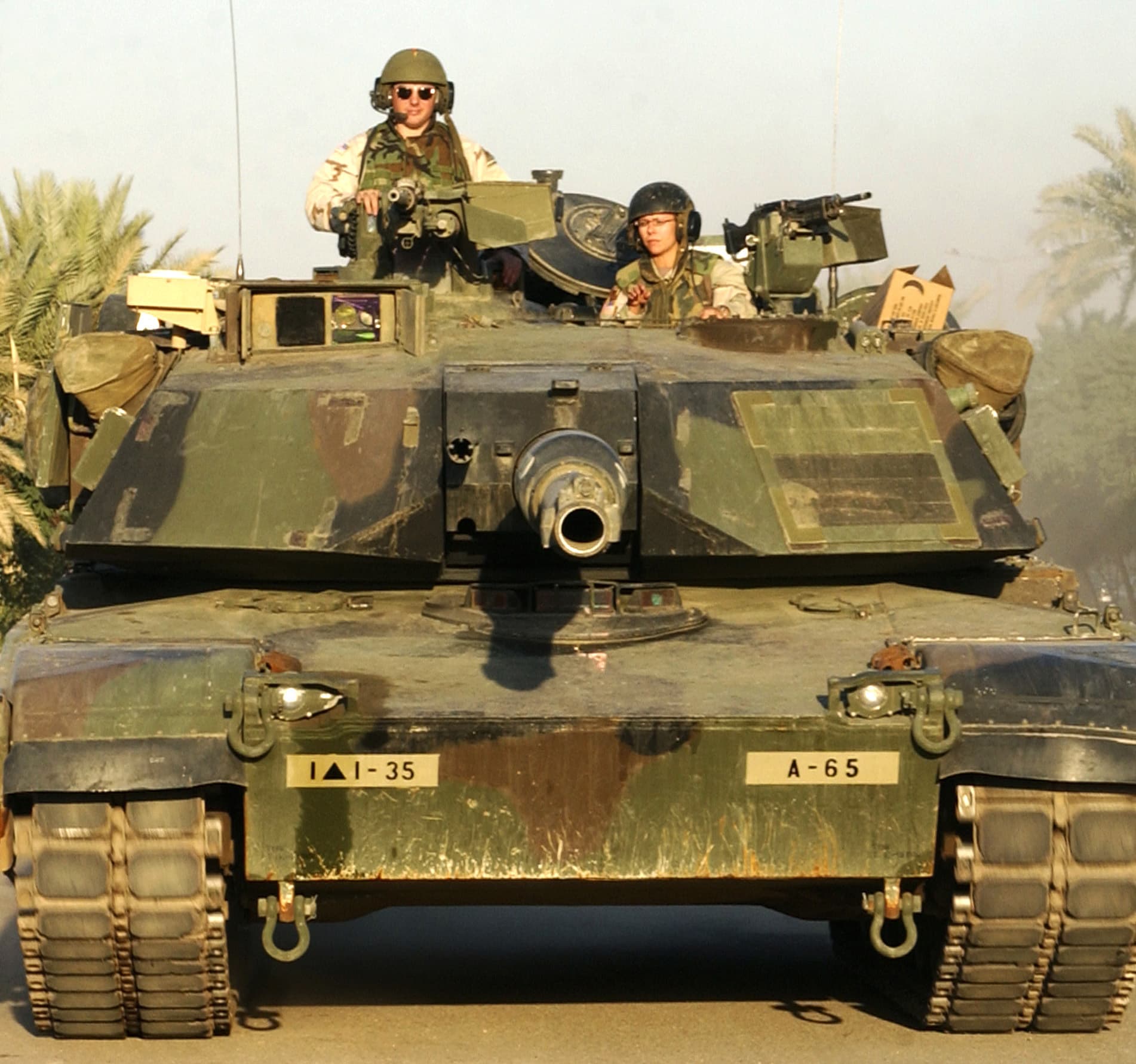 An M1 Abrams main battle tank with its crew advancing in Iraq