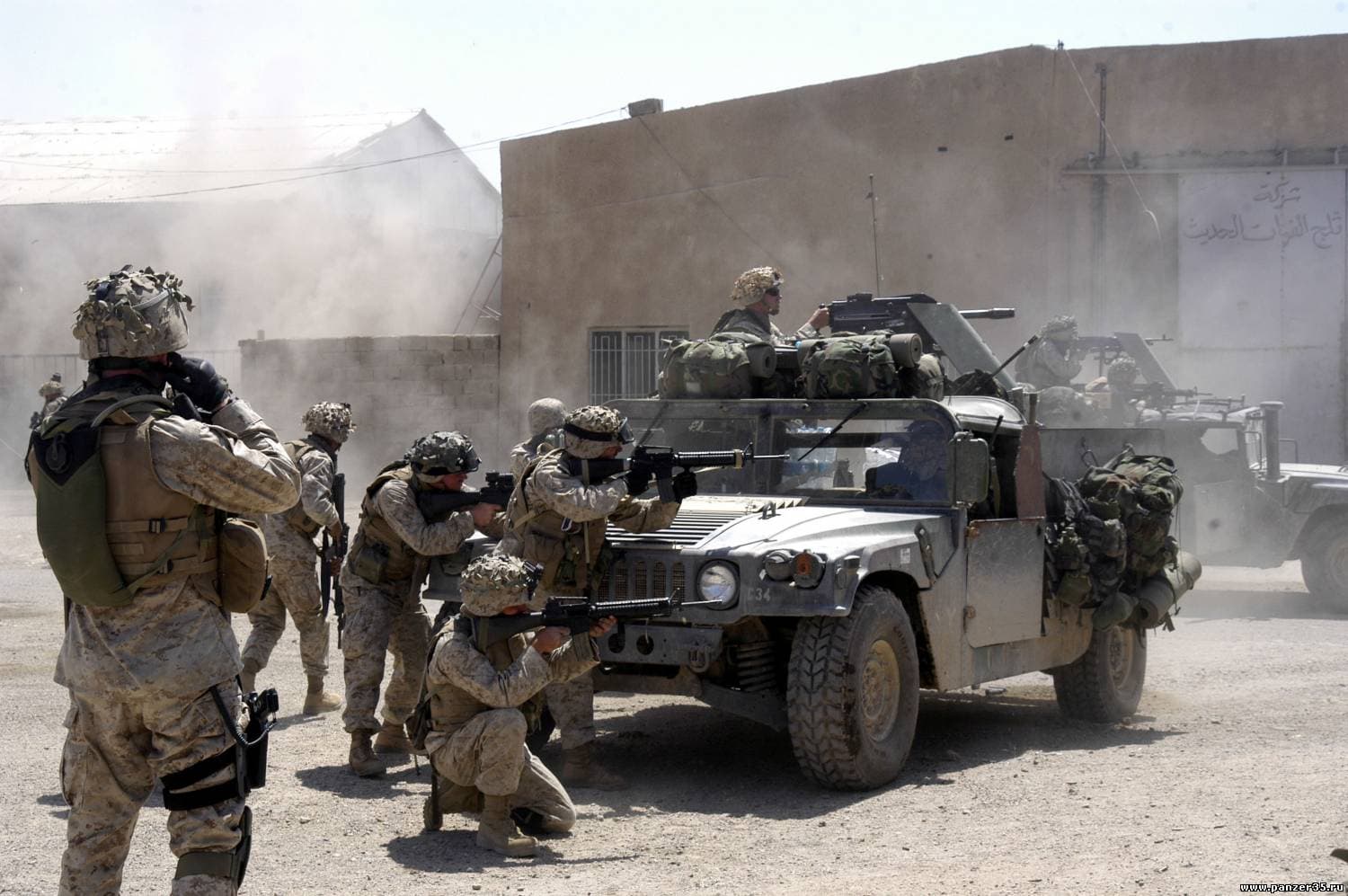 U.S. Marines advancing with a Humvee through urban combat in Fallujah