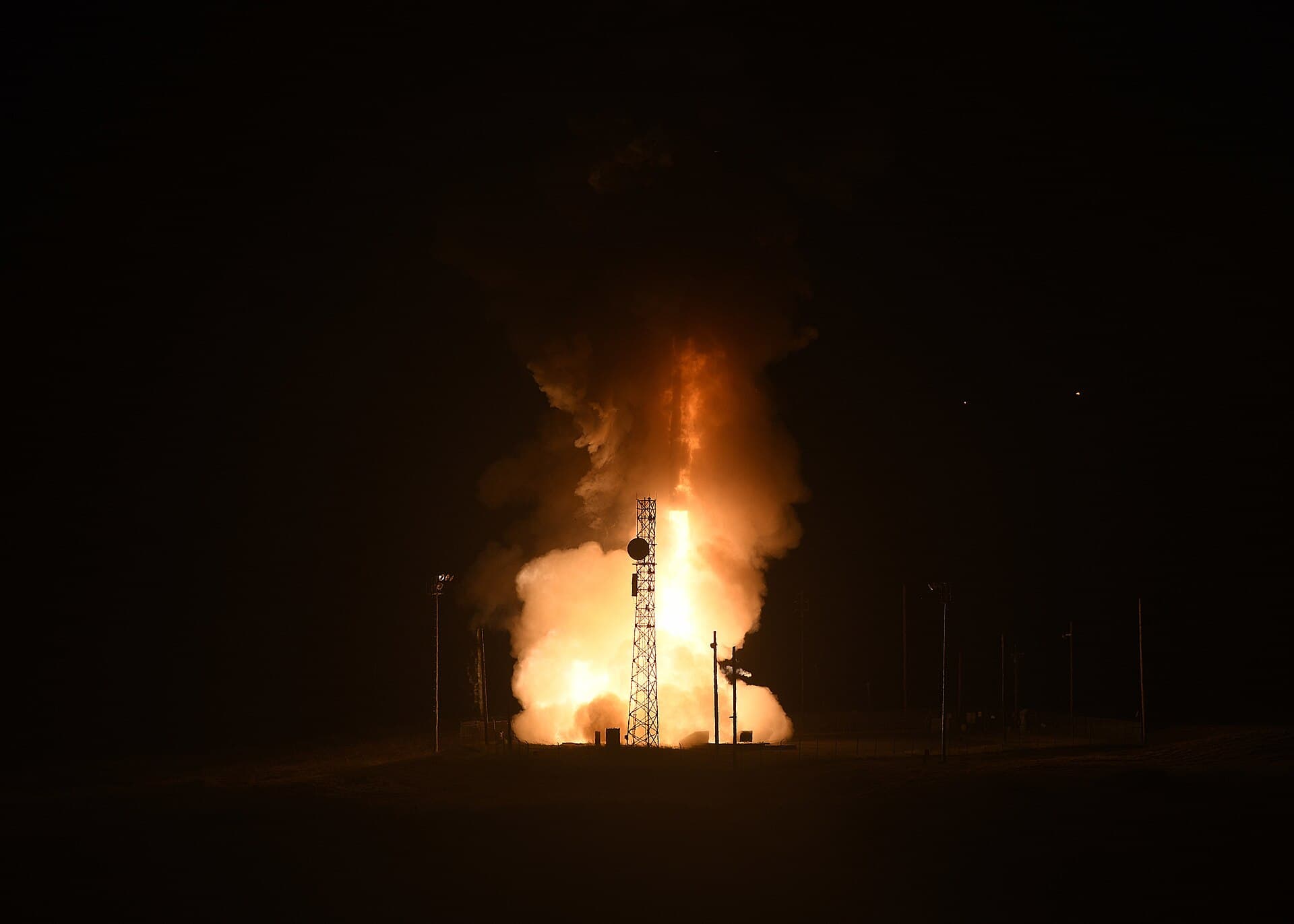 A Minuteman III intercontinental ballistic missile launching at night