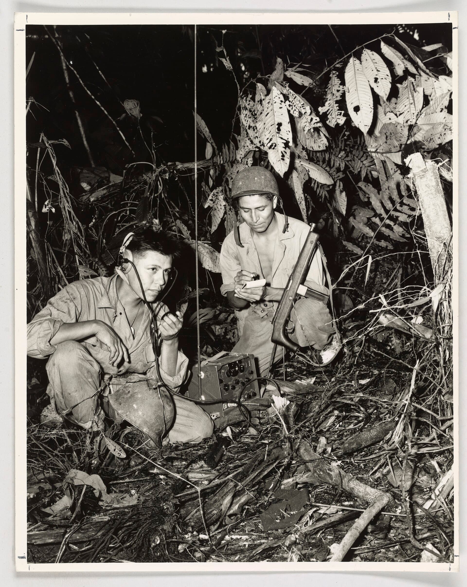 Two Navajo Marine code talkers operating a field radio in the jungle