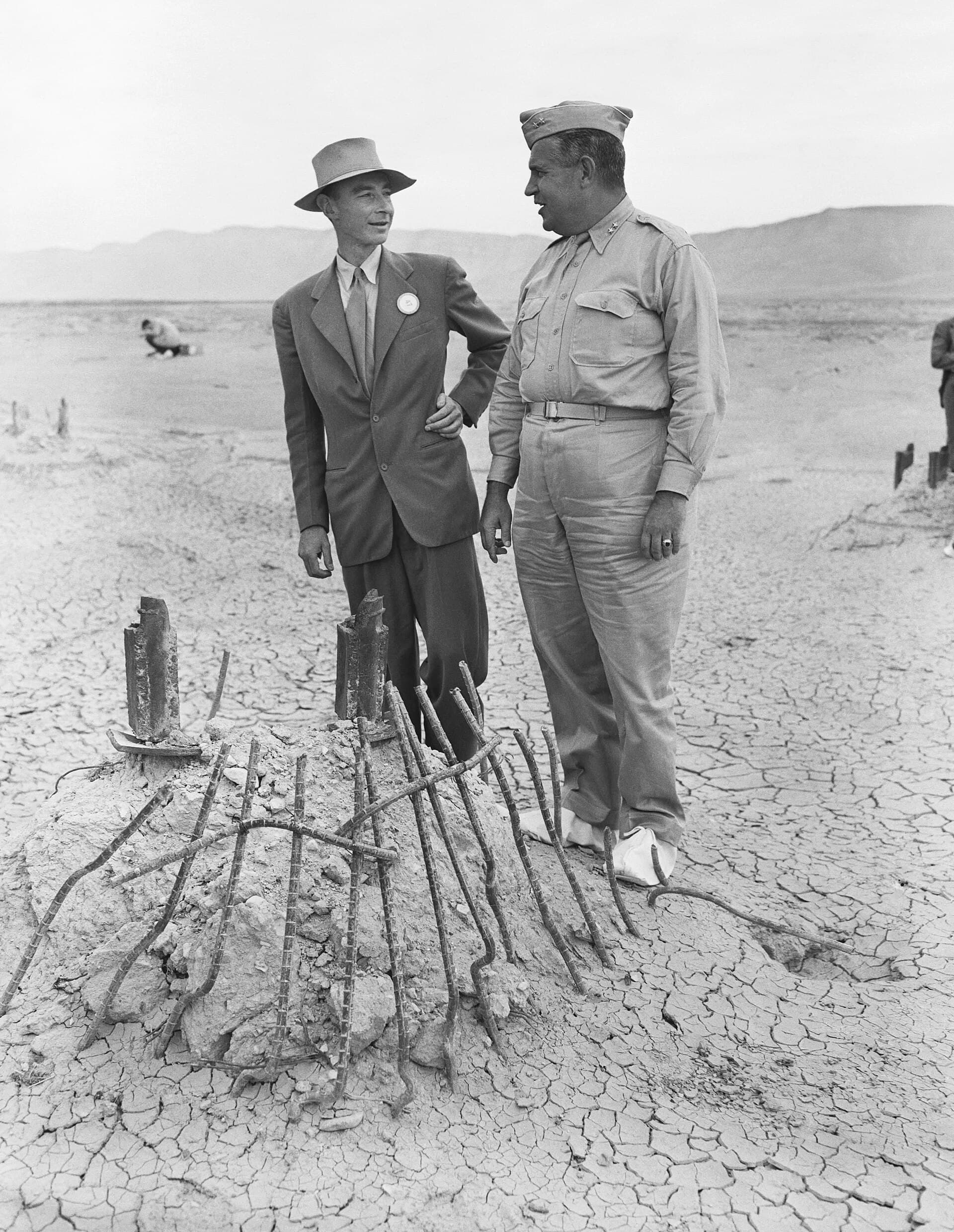 Oppenheimer and General Groves inspecting the twisted remains of the Trinity test tower