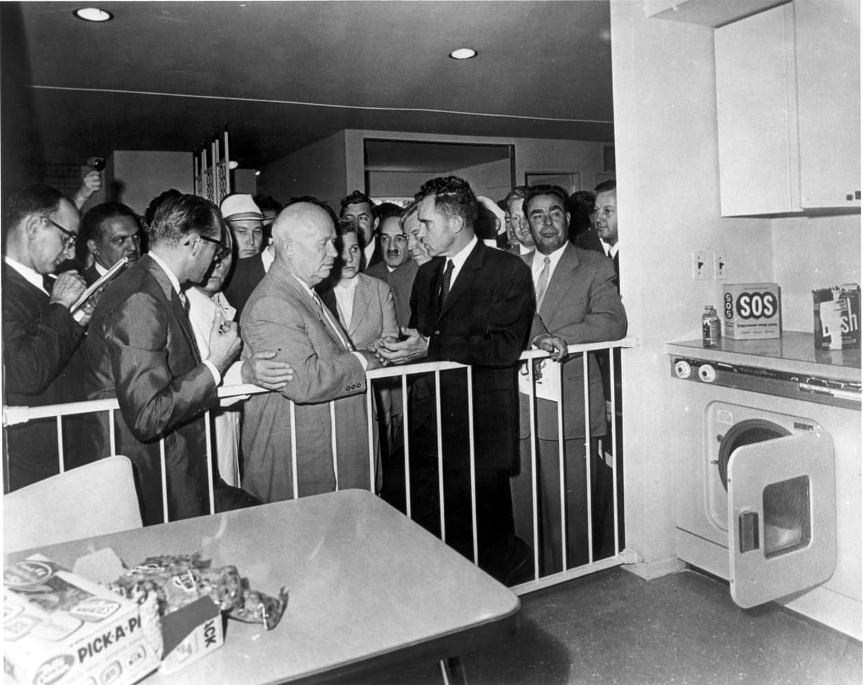 Nixon and Khrushchev debating beside a model American kitchen in Moscow