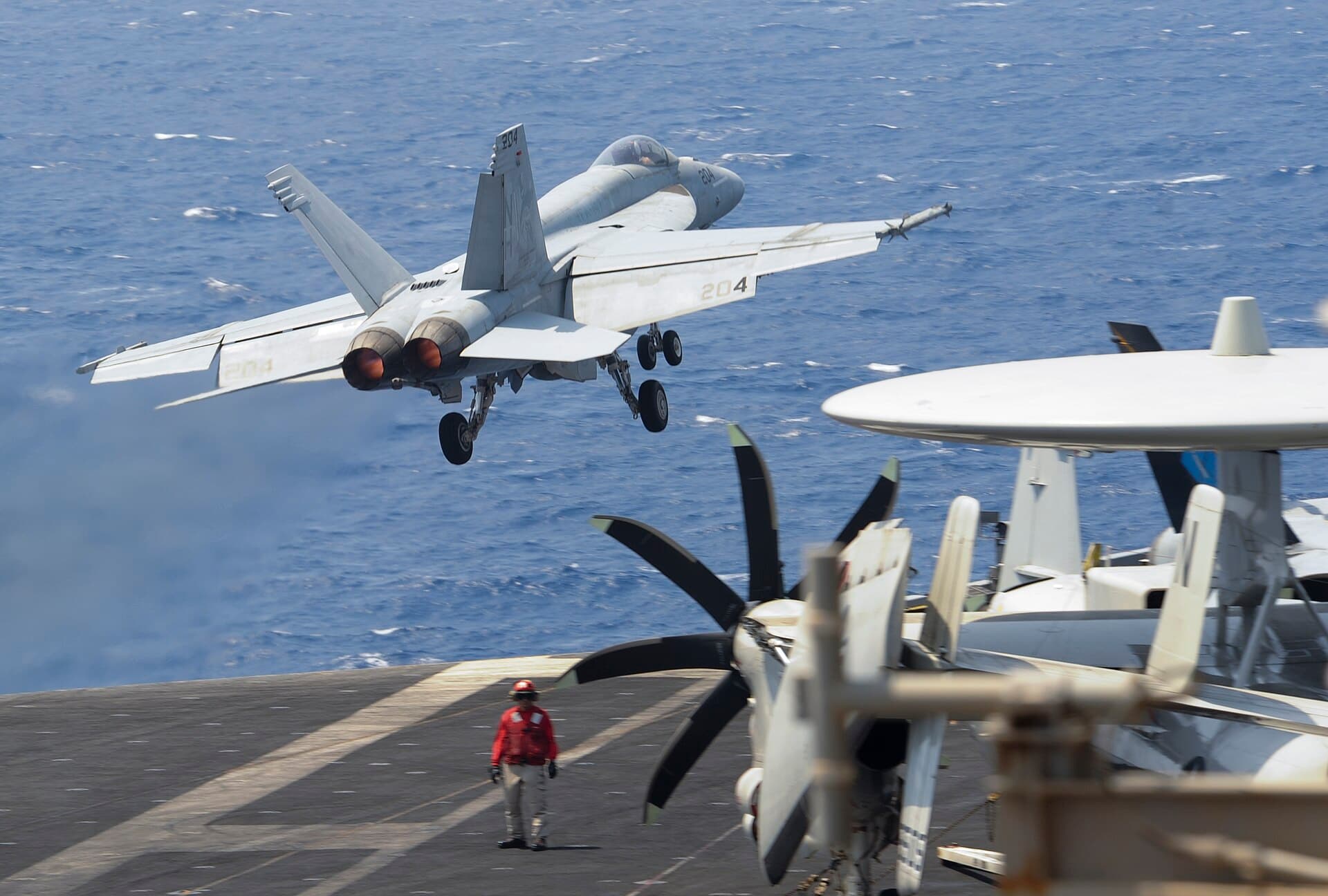 An F/A-18 launching from the flight deck of the nuclear supercarrier USS Nimitz
