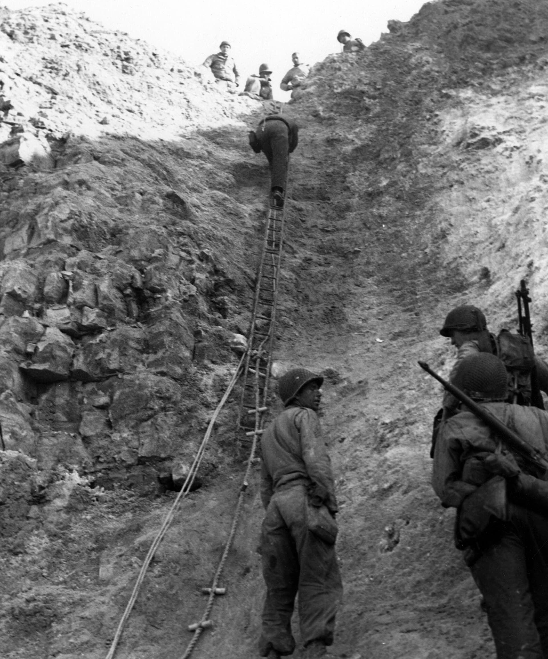 U.S. Army Rangers with ropes and ladders at the cliffs of Pointe du Hoc on D-Day