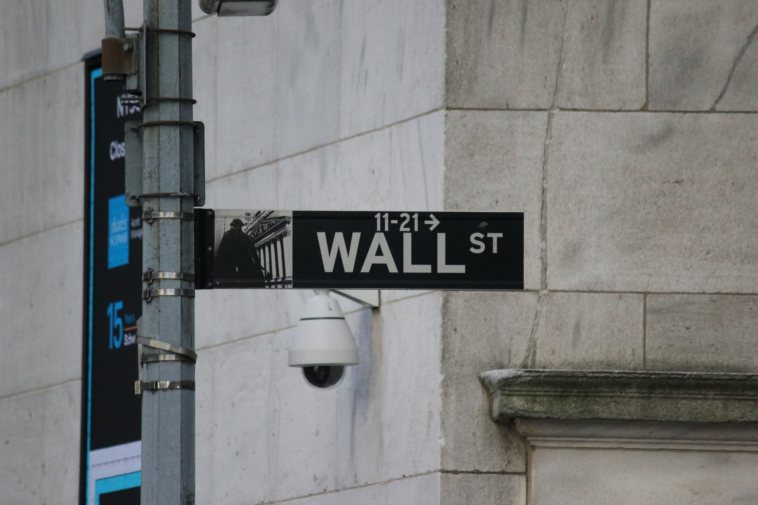 A gallery image from Iconic Symbols: Wall St Sign On Street Pole