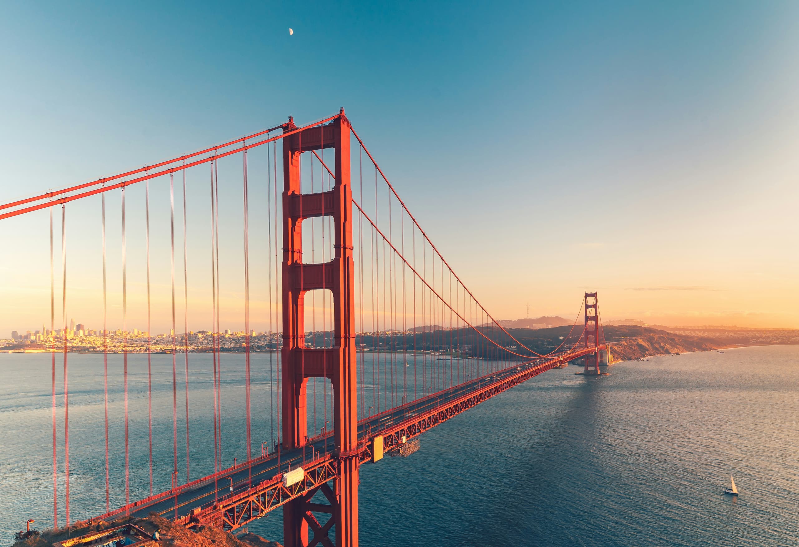 Golden Gate Bridge spanning San Francisco Bay in warm daylight